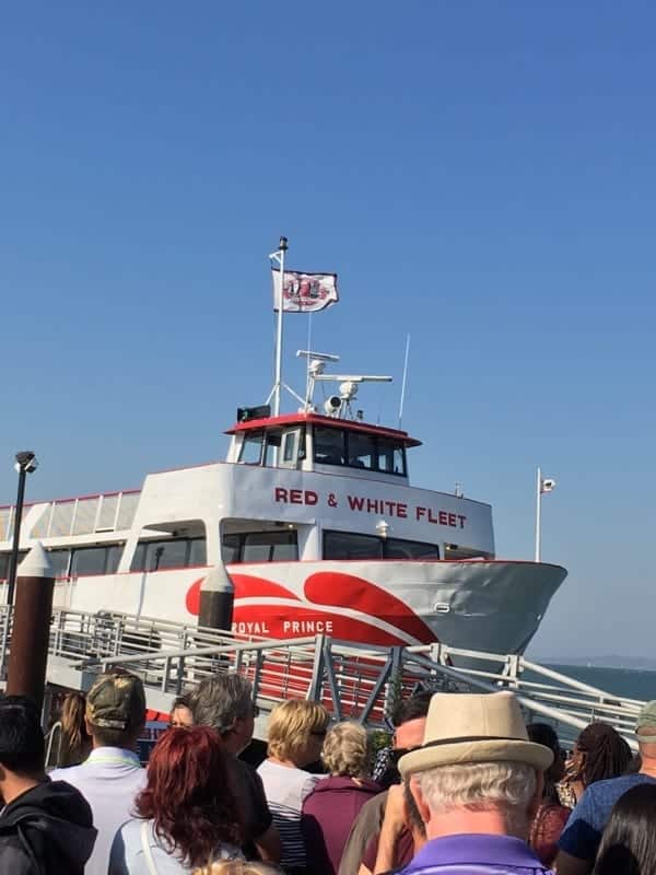 Crowd of people standing in line for a ferry boat