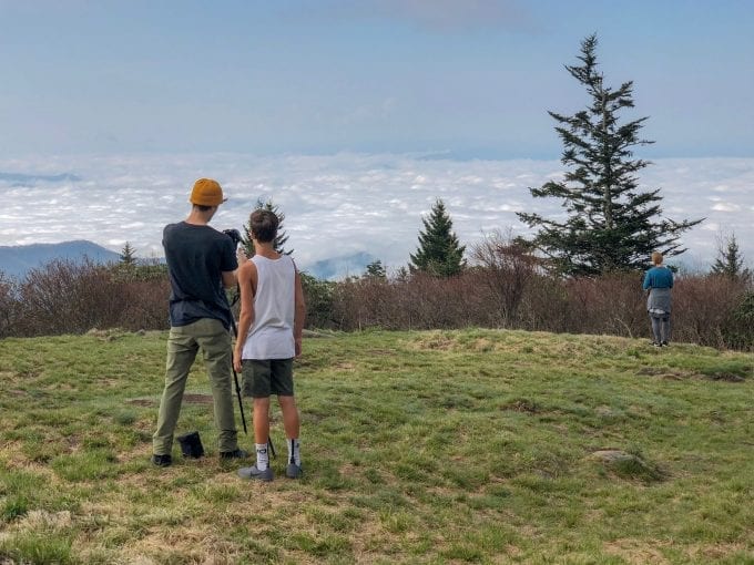 Two hikers photograph the view from Andrew's Bald in Great Smoky Mountains National Park of North Carolina.