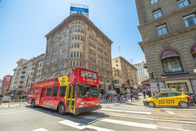 Big Bus Hop On Hop Off Sightseeing Tour, the popular double-decker bus carrying tourists ride in the busy streets of Union Square, San Francisco downtown.