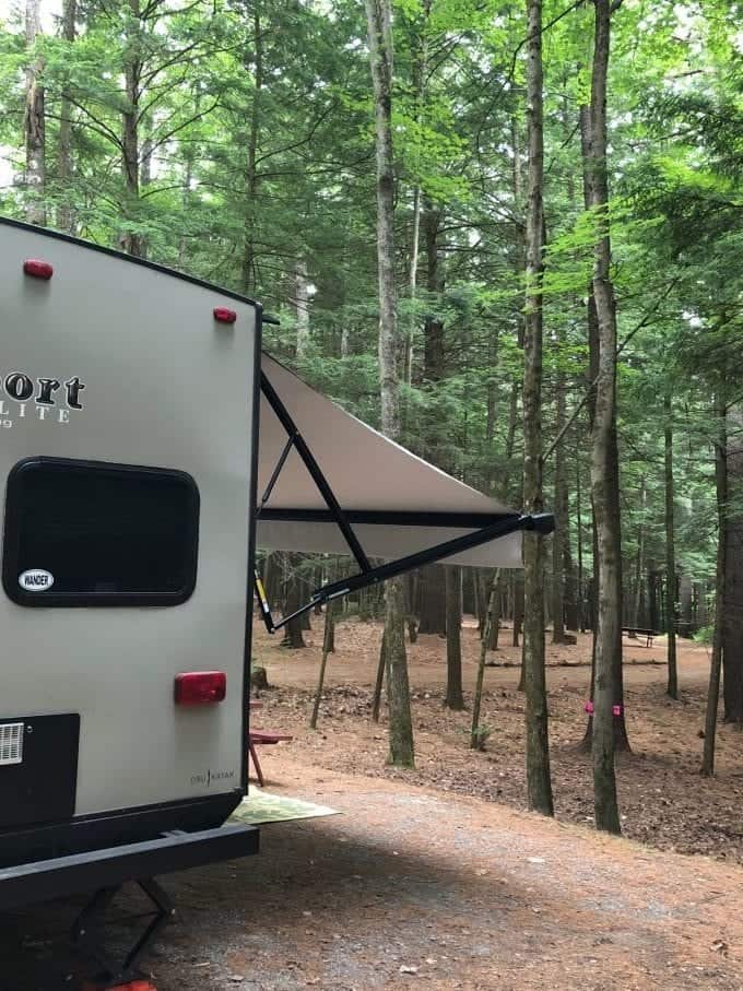 Back exterior view of travel trailer with awning extended.