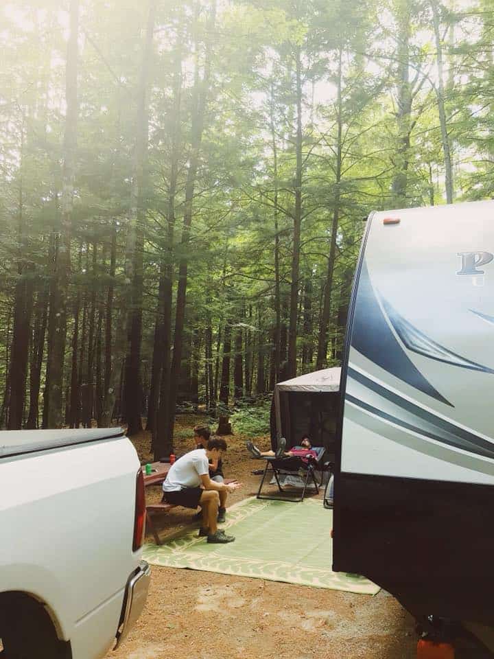 Family relaxing outdoors at a campsite.