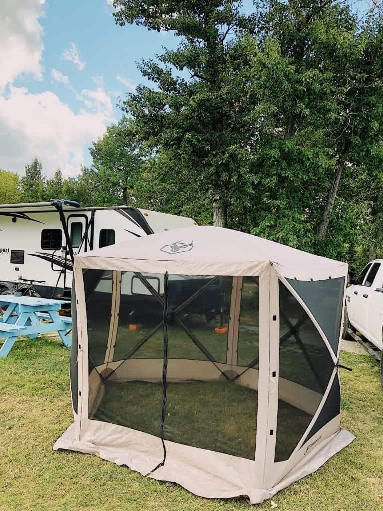 Portable pop up outdoor gazebo pitched at a campsite.