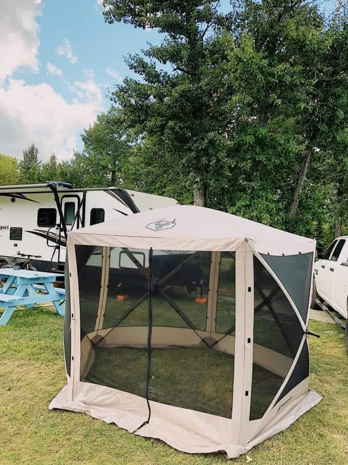 An outdoor pop-up gazebo pitched at campsite.