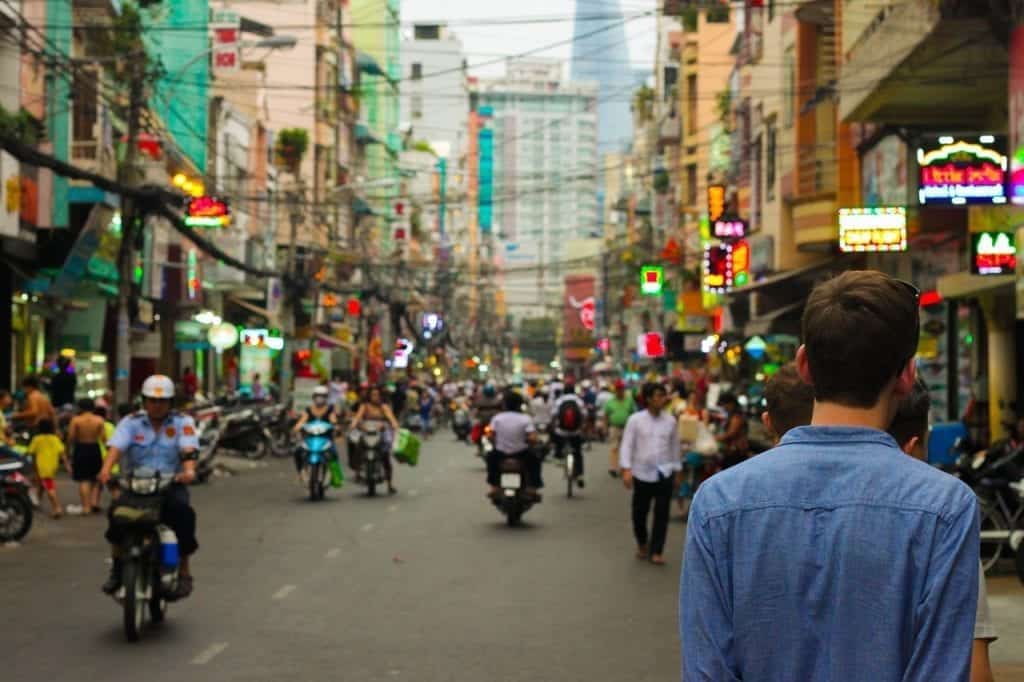 Man walking through busy city streets