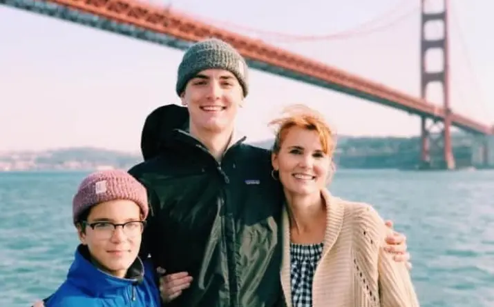 Family posing for picture with a great view of Golden Gate Bridge