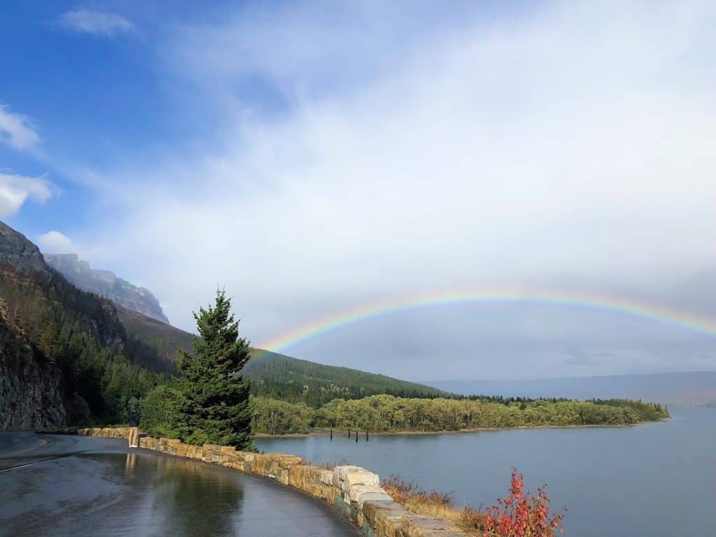 Full rainbow over lake in Glacier National Park