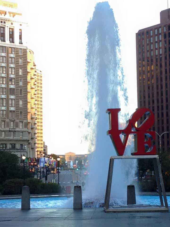 Fountain, city buildings, and LOVE sculpture in Philadelphia