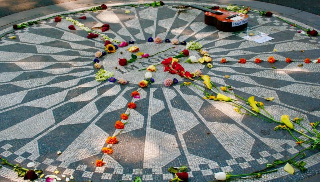 Flowers laid in circle on stone mosaic in New York City.