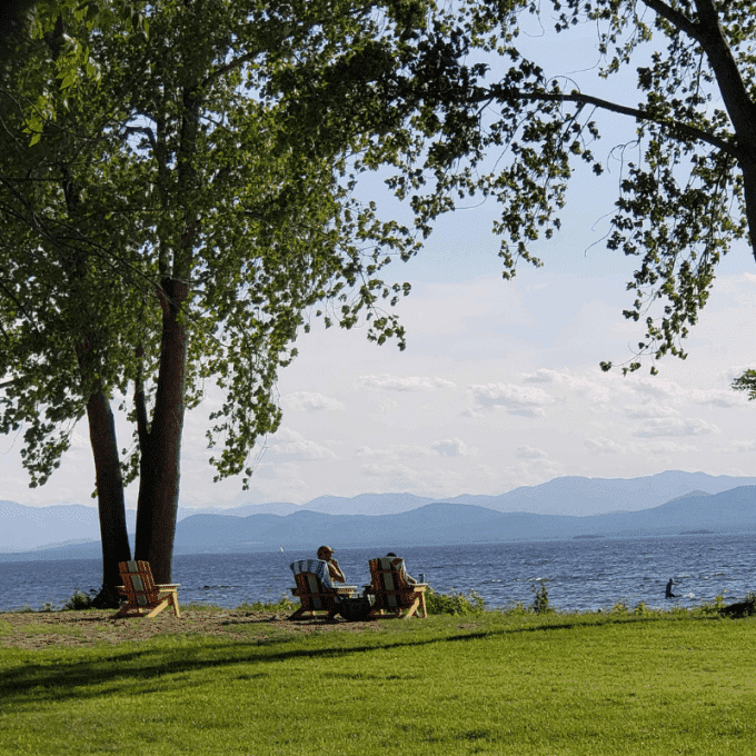 Two people relaxing on outdoor lounge chairs in Burlington, Vermont