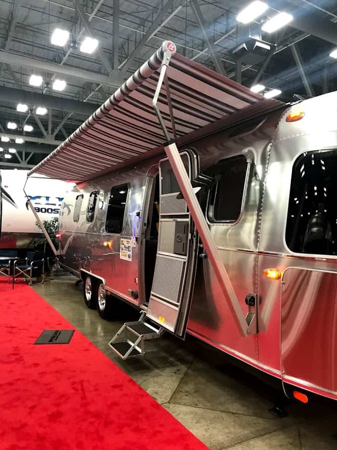 Exterior view of Airstream travel trailer RV with awning at RV Show