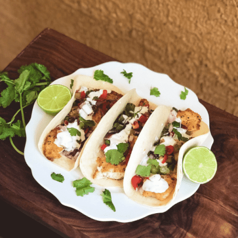 Three tacos on white plate from recipe that can be cooked while RVing