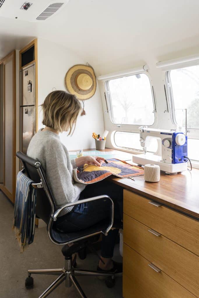 Laura Preston of Simple Geometric Quilting sewing inside RV