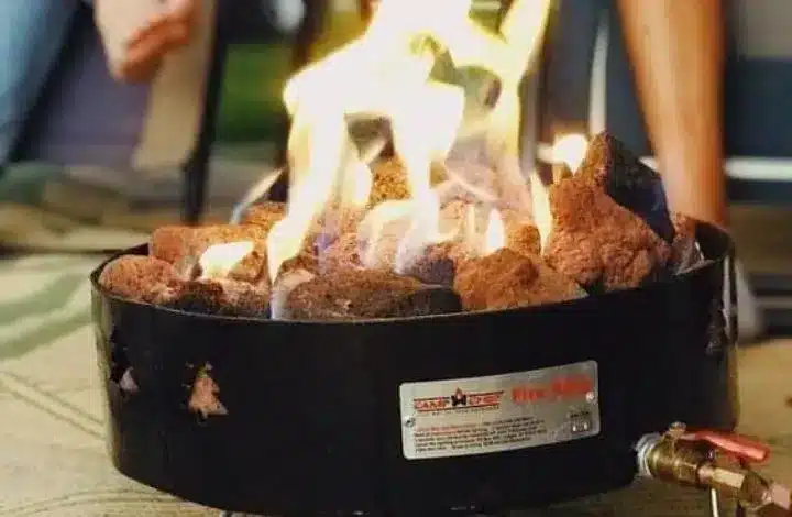 Close up of black portable propane fire pit at campsite