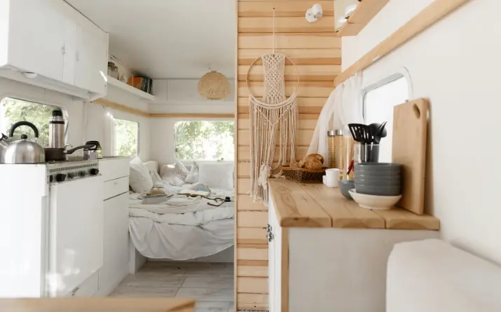 Clean, organized white and wood interior of an RV.