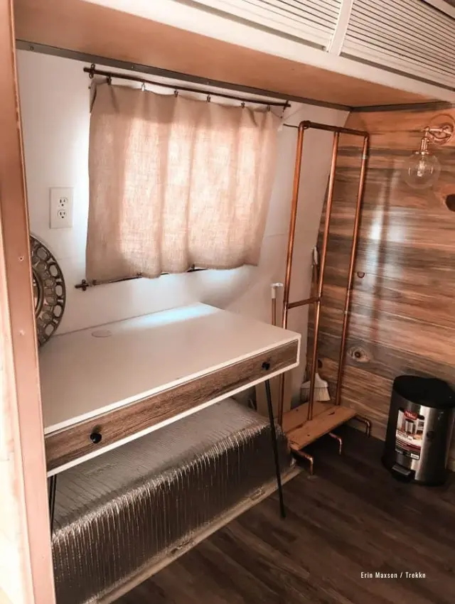 Desk and hanging rod inside travel trailer.