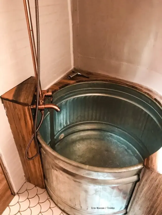 Tub and shower inside travel trailer.