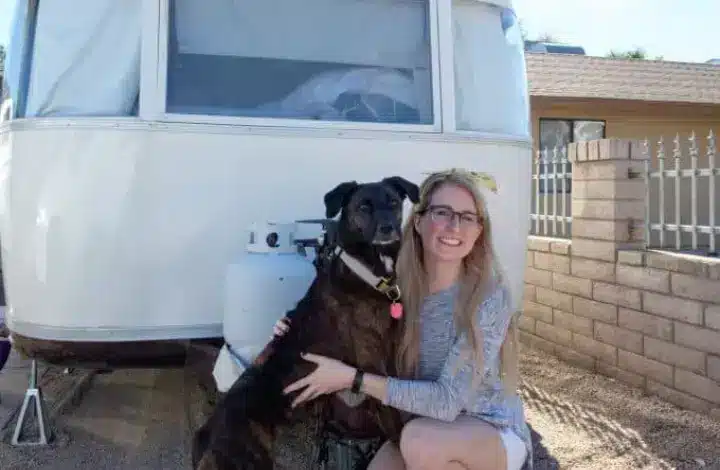 RVing traveler with her dog in front of Airstream RV