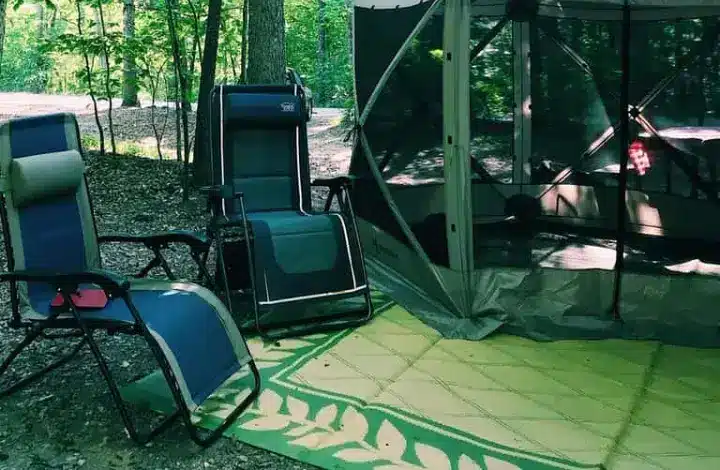 2 blue zero gravity camping chairs next to outdoor gazebo at campsite