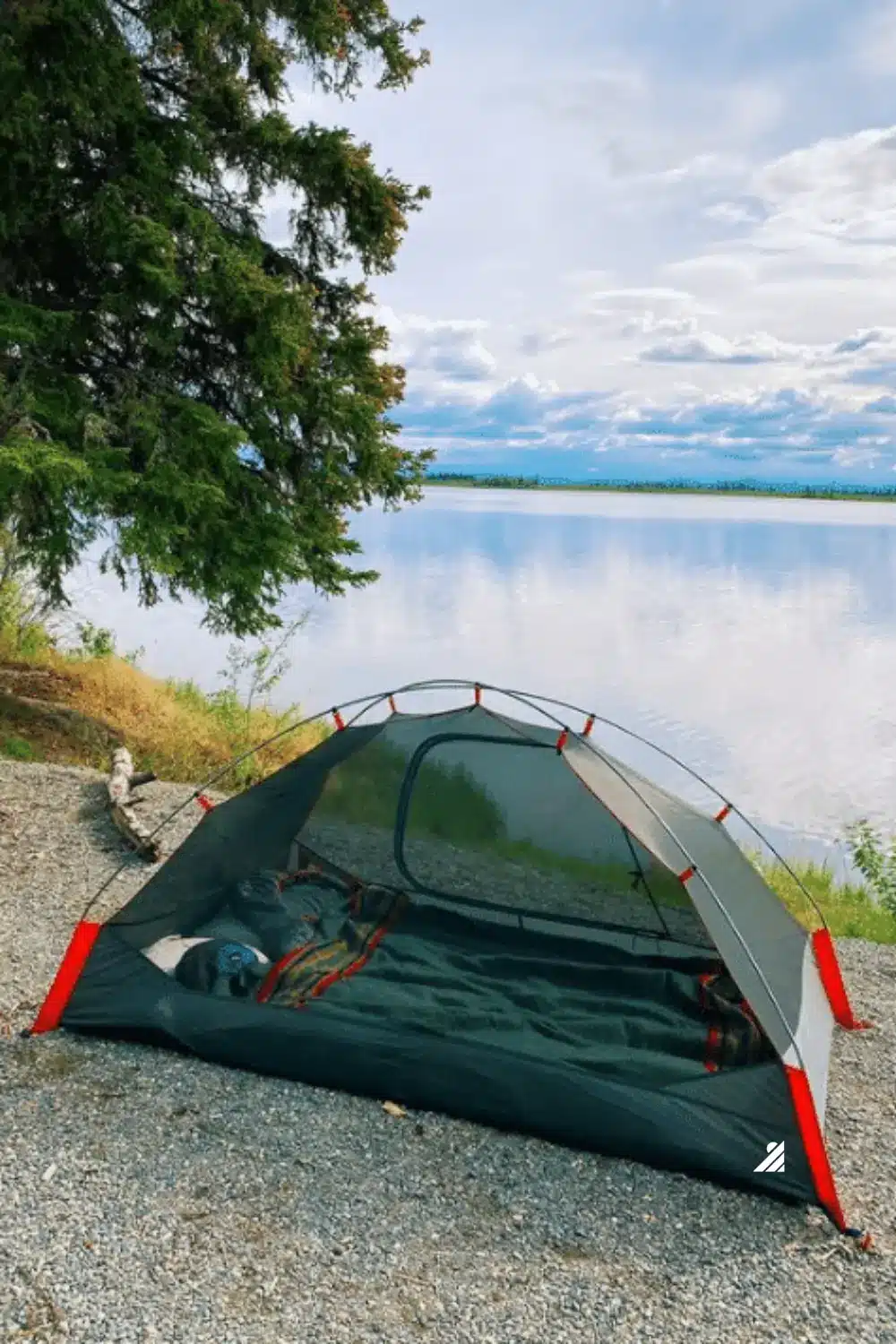 Tent pitched near lake.