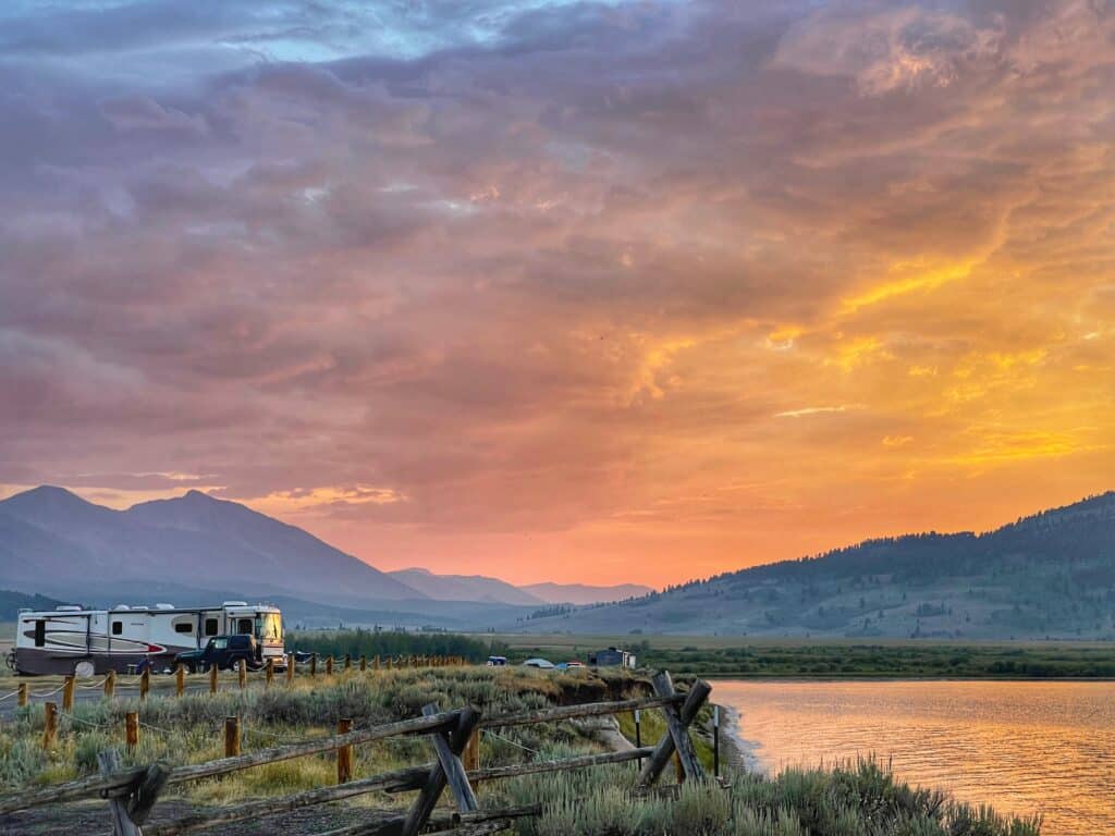 Large RV and Jeep near river