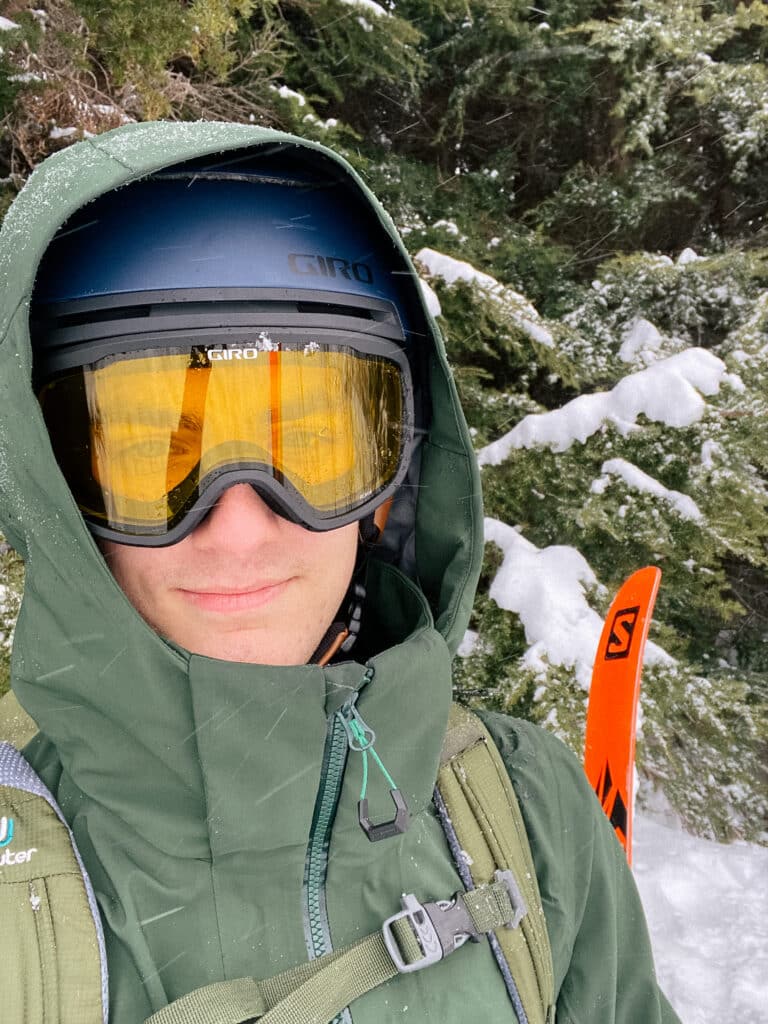 Close up of man wearing ski goggles and outer layer warm jacket