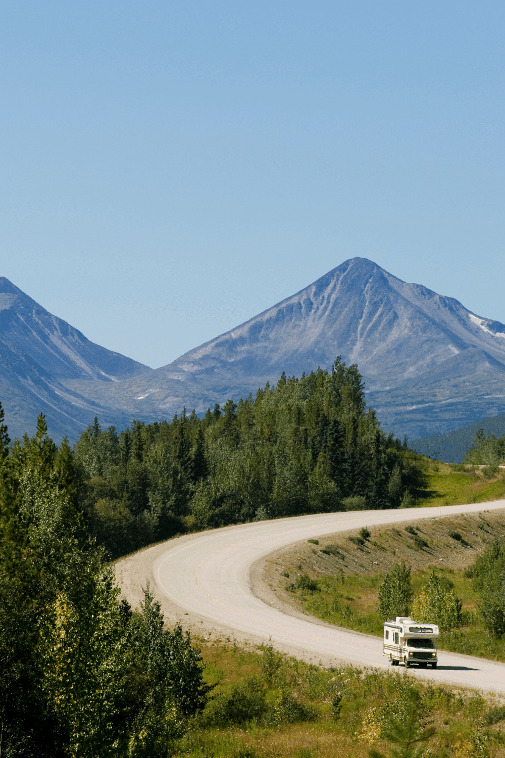 One RV driving down winding road