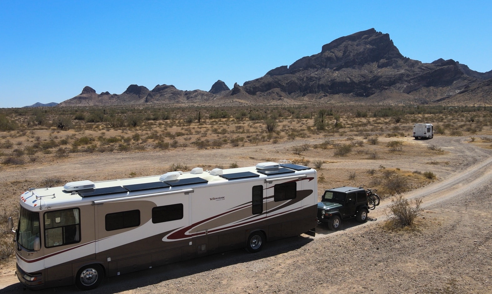 RV pulling Jeep out of boondocking area