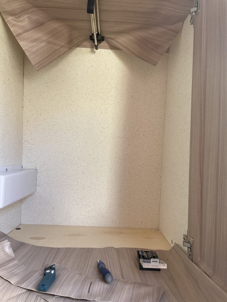 Brown wall paper in camper van being removed