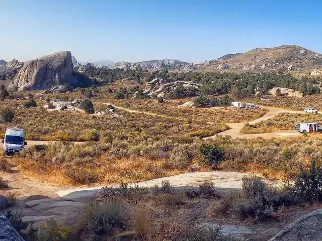 Campervans and RVs spread out on wide open dispersed camping public land