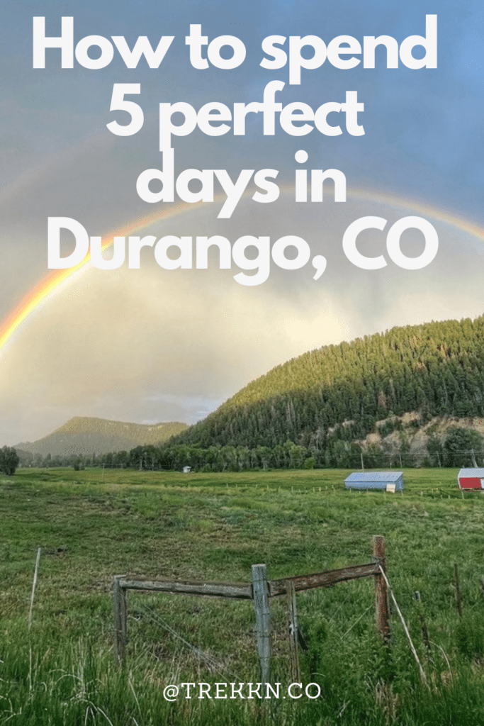 Bright sunlit clouds and rainbow over mountains in Colorado