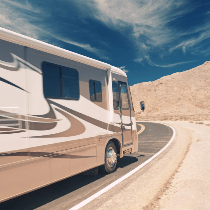 Side of large RV driving around corner