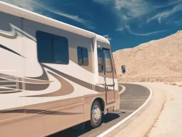 RV driving around corner on open road