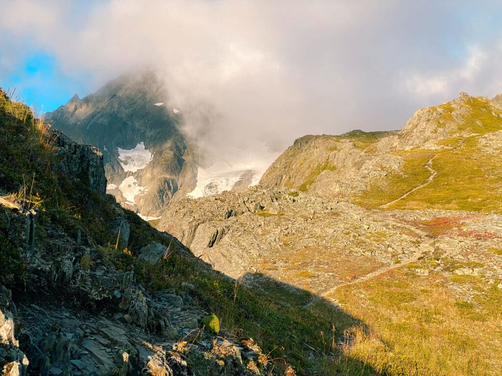 The peak of Mount Alice looming out of the cloud cover