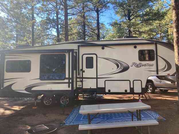 33 foot RV parked next to picnic table at the best campsite this big rig could find