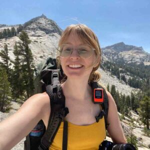 Woman wearing backpack hiking solo