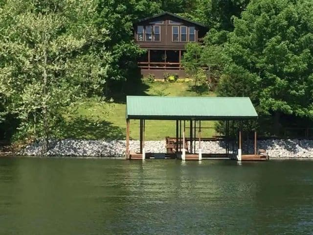 Brown cabin on slope seen from Lake of Egypt in Southern Illinois