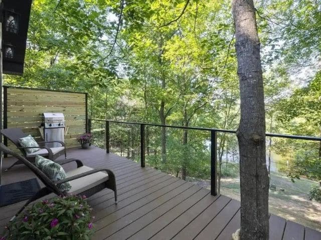 Outdoor lounge chairs on deck of custom-built tree house