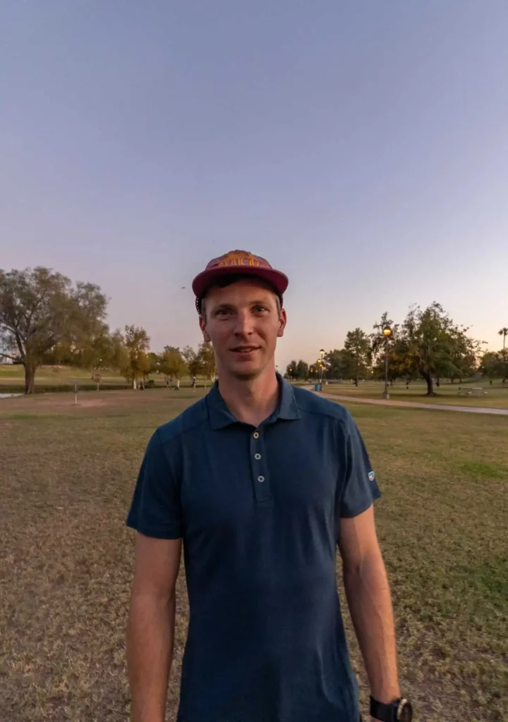 Man in hat and blue Kuhl hiking shirt