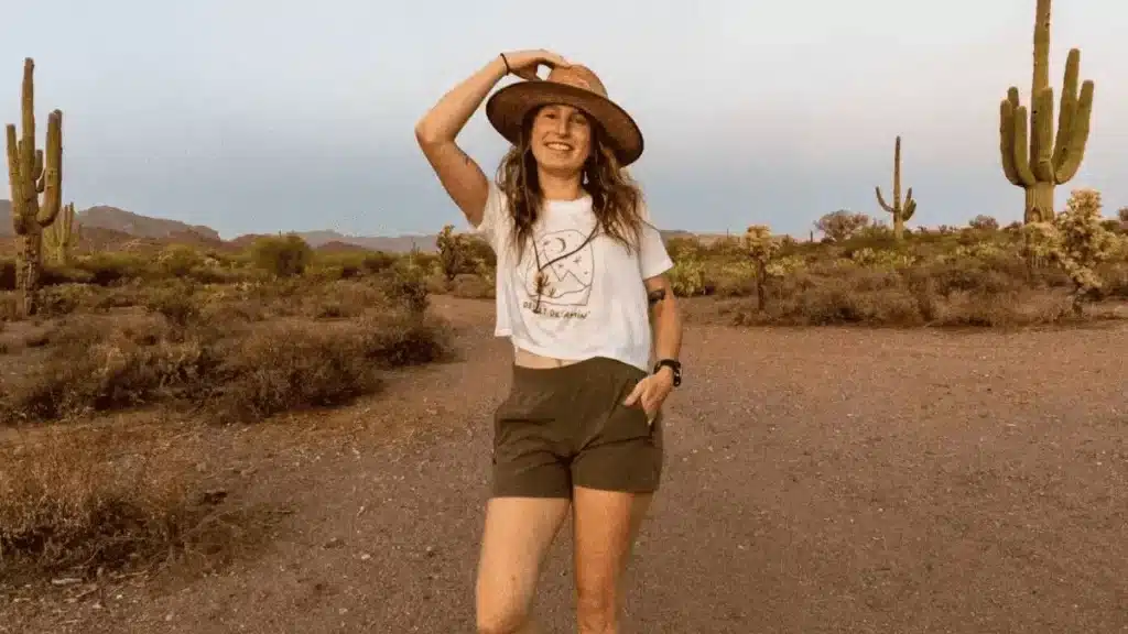 Woman wearing white shirt and hiking shorts in camping area