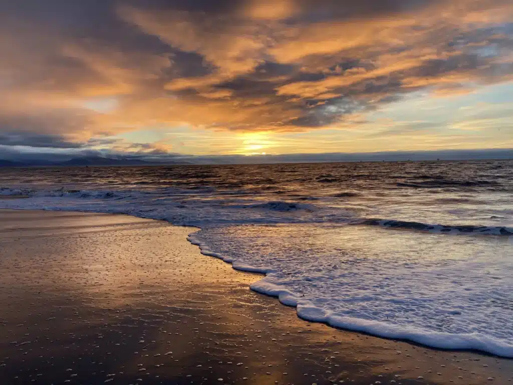 Calm foamy tide coming in along Santa Barbara beach shore