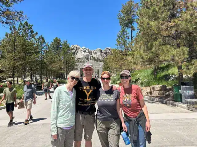 Family poses in front of national park monument