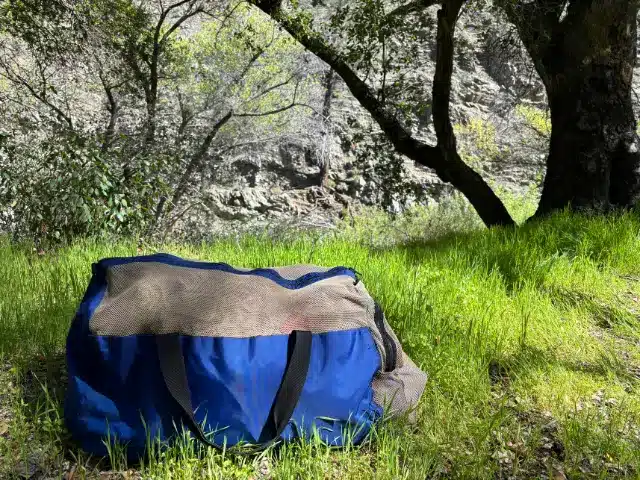 Brown and blue bag used to pack all tent camping gear