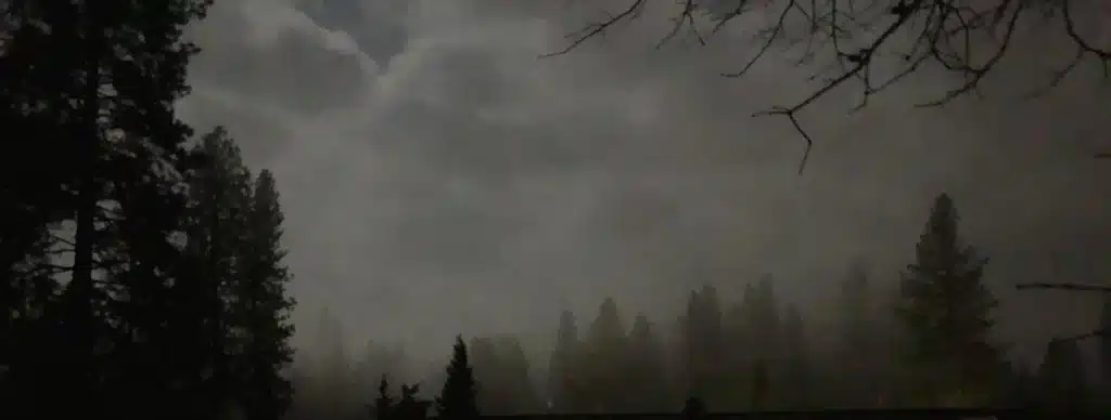 Spooky cloudy dark sky at night while camping.